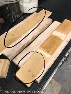 three pieces of wood sitting on top of a counter