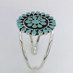 "This stunning Squash Blossom bracelet was handcrafted in Mexico. Each teardrop bezel is inlaid with turquoise coloured enamel enhanced with tiny brown flecks. Surrounding the centre blossom is a woven wire accent. The dimensions of the bracelet are approximately 8\" inches in circumference. This cuff can be adjusted down to 7\" and up to 8.5\" This piece is silver plated. The pattern of the enamel may vary very slightly, they are all individually hand crafted. If you've got any questions don't Southwestern Turquoise Bangle, Southwestern Style Turquoise Cuff Bracelet, Southwestern Style Round Turquoise Cuff Bracelet, Bohemian Turquoise Inlay Cuff Bracelet, Bracelet Mexican, Turquoise Squash Blossom, Navajo Style, Mexican Jewelry, Squash Blossom