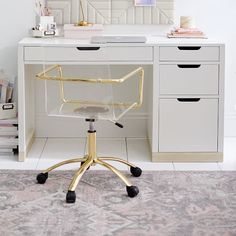 a white desk with a gold chair in front of it