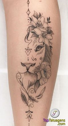 a woman's leg with a lion tattoo and flowers on her head, as well as an arrow