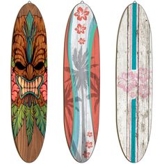 three surfboards with designs on them are lined up against a white background and one has an image of a tiki