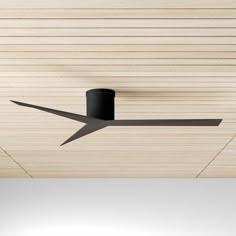 a ceiling fan mounted to the side of a wooden ceiling