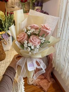 a bouquet of pink roses sitting on top of a table