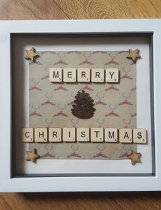 a scrabbled christmas card with the words merry and a pine cone on it