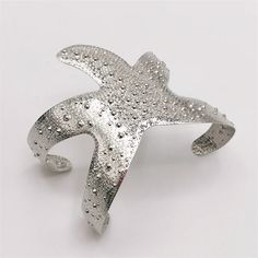 This stunning piece features a wide cuff design adorned with intricate starfish details. Made with exquisite craftsmanship, it adds a touch of elegance to any outfit. - Color: Gold, Silver - Material: Stainless Steel - Style: Bracelet - Gender: Women Elegant Starfish Bracelet For Gift, Elegant Starfish Bracelets For Beach, Elegant Silver Starfish Jewelry, Cuff Design, Jewelry Gothic, Bohemia Style, Starfish Bracelet, Cuff Bracelets Handmade, Luxe Jewelry