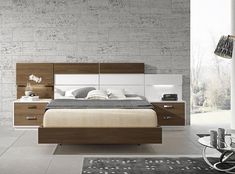 a modern bedroom with white and brown furniture