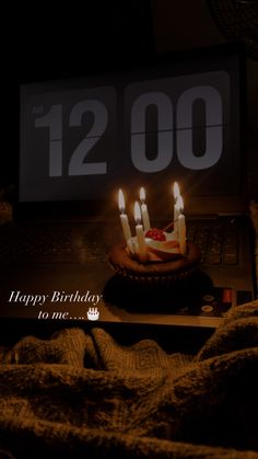 a birthday cake with lit candles sitting in front of a laptop computer that reads 1230 happy birthday to me