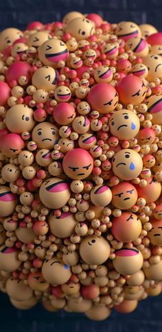 a bunch of balls with faces on them are arranged in the shape of a ball