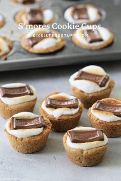 mini s'mores cookie cups are sitting on a baking sheet and ready to be eaten