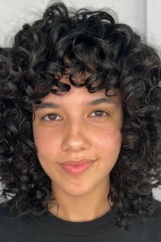 This popular chin-length haircut has lots of beautiful defined curls that flow down and give the hair both thickness and bounce, looking very nice framing the face. The curls have different layers visible thanks to subtle colored pieces added in that make the texture and how it moves stand out more, creating a fun - Click to see more of 2024's Hottest Trend: 33 Stylish Chin-Length Curly Haircuts for a Chic Look! and follow us for more hairstyle ideas. // Photo Credit: Instagram @myfavstylists Curly Haircuts