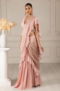 Peach pre-draped ruffle trim saree with placement embroidery work. Paired with a floral butti embroidered blouse. - Aza Fashions Draped Blouse With Ruffles, Fitted Draped Blouse With Ruffles, Summer Reception Draped Dress, Placement Embroidery, Ruffle Sarees, Ruffle Saree, Drape Saree, Saree With Blouse, Embroidery Work