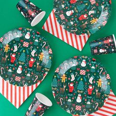 christmas themed paper plates and napkins on a green surface