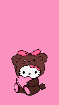 a brown teddy bear with a pink bow on its head