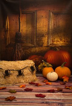 pumpkins and hay bales on a striped tablecloth