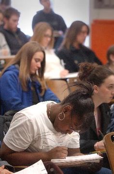 people sitting at desks in a classroom