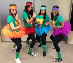 four girls dressed in costumes posing for the camera