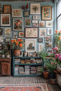 a room filled with lots of framed pictures and flowers