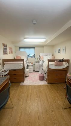 a room with three beds and two desks