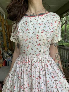 "Sooo darling. I picture this becoming someone's favorite summer dress. 1950's Julie Miller of California cotton micro floral blush pink fitted dress with full skirt. Demure and beautiful at the same time. Bust: 34\" max Waist: 24\" max Hips: free Length: 38\" Model is 5'7\" and 115 lbs with measurements of 32x24x34. Buy with confidence as all photos are taken in natural lighting." 1950s Style Floral Print Short Sleeve Dresses, 1950s Short Sleeve Vintage Dress For Garden Party, Spring Vintage Fit And Flare Dress, 1950s Vintage Spring Dress With Short Sleeves, 1950s Vintage Short Sleeve Dress For Spring, 1950s Style Short Sleeve Vintage Dress For Spring, 1950s Style Vintage Dress For Spring Garden Party, Vintage Pink Dress With Rose Print, Vintage Pink Rose Print Dress