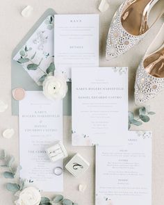 the wedding stationery is laid out and ready to be put into the bride's shoes