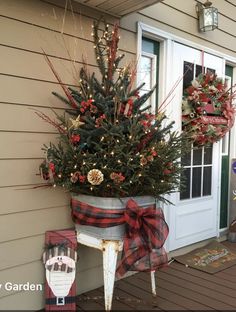 a potted christmas tree sitting on top of a porch