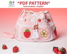 a pink crocheted purse with strawberries on it