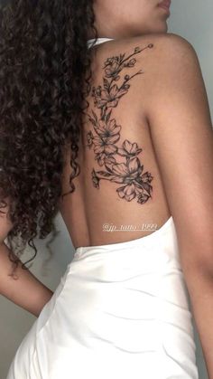 the back of a woman's shoulder with flowers on it