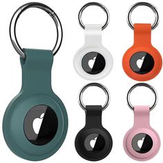 four key chains with an apple logo on one side and two different colors on the other