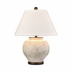 a table lamp with a white shade on it