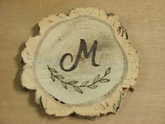 a piece of wood with the letter m on it