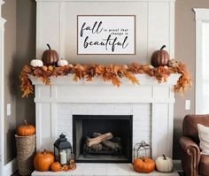 a fireplace decorated with fall leaves and pumpkins