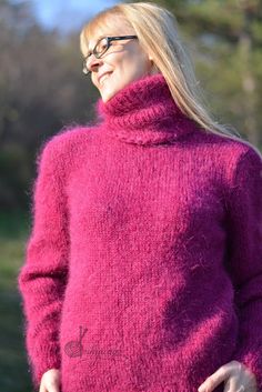 a woman wearing a pink sweater and glasses