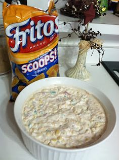 a bowl of oatmeal next to a bag of frito's