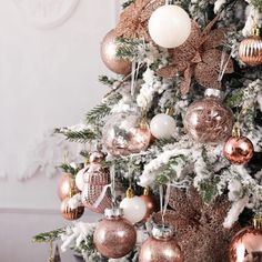 a decorated christmas tree with pink and gold ornaments