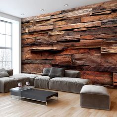 a living room with wood paneling on the wall and couches in front of it