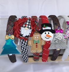 a group of christmas ornaments sitting on top of a wooden shelf next to each other