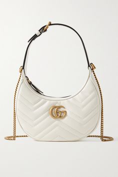 Gucci's 'Marmont' bag has a timeless, vintage feel - from the antique gold-tone hardware to the chain shoulder strap. It's been crafted in Italy from supple white leather in a crescent moon shape and is detailed with the house's 'GG' moniker. The top unzips to reveal a handy slip pocket for your most-used cards. Gucci Bag Marmont, White Gucci Bag, Leather Hand Bags For Women, Expensive Bag, Luxury Bags Collection, Gucci Handbag, Gucci Marmont, Luxury Purses, Fancy Bags