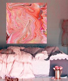 a painting is hanging on the wall above a bed