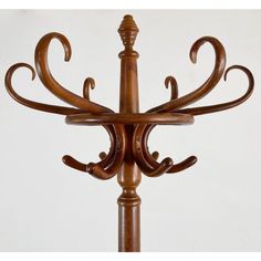 an ornate wooden coat rack on a white background