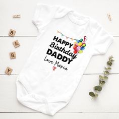 A personalized baby bodysuit with the design name "Happy Birthday Mommy or Daddy" is a charming and heartwarming gift to celebrate a special occasion for a new parent. Made from soft and comfortable cotton material, this bodysuit is perfect for newborns and infants up to 24 months old. The design features a sweet message of "Happy Birthday Mommy or Daddy" printed in bold and vibrant colors, making it a standout piece in any baby's wardrobe. The text is surrounded by fun and playful illustrations Personalized Fitted Onesie For Birthday, Father's Day Gift Cotton Onesie, Playful Cotton Bodysuit As A Gift, Playful Short Sleeve Bodysuit For Birthday, Father's Day Family Matching Onesie, Cotton Birthday Onesie For Father's Day, Family Matching Cotton Onesie For Birthday, Cotton Birthday Onesie, Personalized Family Matching Onesie For Birthday