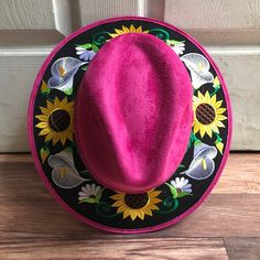 Stand out with this beautiful handcrafted Mexican Suede Hat with beautiful detailed floral embroidered canvas brim. Perfect accessory to add that with that daily outfit. MADE IN MEXICO By: Mexican Artisans For: Women Size: Medium 23' Color: magenta | multi Details: Top Suede Embroidered canvas brim Inner elastic band Contact us for more details PLEASE READ BEFORE PURCHASE: The picture is an ACCURATE REPRESENTATION.Colors in the pictures may vary a little by effects of light. Each product is hand Spring Festival Costume Hat With Short Brim, Traditional Wide Brim Fitted Hat, Traditional Fitted Wide Brim Hat, Embroidered Fitted Cap, Spring Embroidered Flat Brim Hat, Fitted Brimmed Felt Hat For Festivals, Pink Embroidered Hats With Curved Brim, Pink Embroidered Hat With Curved Brim, Traditional Wide Brim Hat For Spring