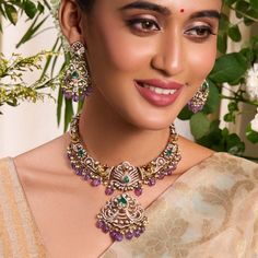 Description: Indulge in the vintage elegance of the Yasmin hasli necklace set. Inspired by India's rich jewelry heritage, it features opulent Moissanite stones, nakshi motifs, and a central peacock motif surrounded with bird and floral patterns. Crafted in 925 silvers with Victorian plating, sapphire beads, and cluster pearl drops, it exudes vintage charm. Product Information: Metal: 925 Silver with Victorian Plating Length: Necklace- 18cm, Earrings- 7cm Stones: High Grade CZ Stones Findings: Ho Chandbali Temple Necklace For Formal Occasions, Formal Chandbali Temple Necklace, Ornate Kundan Jewelry Sets Hand Set, Ornate Kundan Necklace For Reception, Ornate Chandbali Necklaces With Stone Work, Ornate Chandbali Stone Work Necklaces, Heavy Chandbali Temple Necklace For Formal Occasions, Ornate Festive Necklaces For Reception, Ornate Hand Set Chandbali Kundan Necklace