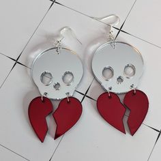 These earrings will remind you that hearts are fragile so take good care of yours! A silver skull carries the pieces of a broken red heart. Laser cut out of mirror acrylic, they’ll catch the light and shine just like your heart. each earring is about 73mm long by 37mm wide hypoallergenic earring hooks silver tone jewelry findings Edgy Red Earrings As Gift, Edgy Red Earrings For Gift, Edgy Red Earrings For Gifts, 3d Printing Diy, Mirror Acrylic, Hypoallergenic Earrings, Earring Hooks, Polymer Clay Jewelry, Cute Jewelry