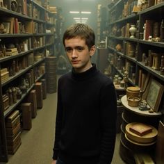 a man standing in front of a bookshelf filled with shelves full of books