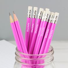 several pink pencils are in a glass jar