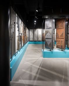 a room filled with lots of different types of wall hangings and glass cases on the walls