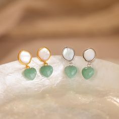 Discover the enchanting beauty of the land and sea with our Jade Heart Drop Earrings ✨ Featuring a lustrous Mother of Pearl and vibrant Jade gemstone, these earrings add a sophisticated pop of color to any look, a must-have for those who appreciate nature-inspired jewelry. SKU: RR-ER542 Product Details Material: High Quality Solid 925 Sterling Silver Finish: 18K Gold ∙ Sterling Silver Featuring dainty Stud Earrings with a ~8mm Mother of Pearl and ~8mm dangling Jade Heart Gemstone Sold as a pair Land And Sea, Initial Gifts, Jade Gemstone, Dainty Studs, Heart Drop Earrings, Heart Gemstone, Nature Inspired Jewelry, Station Necklace, Inspired Jewelry