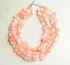 A beaded multi strand statement necklace made with peach Lucite beads of various shapes. - Necklace has 5 strands (more strands available)- Shortest strand measures 18 - 20" long- Lobster claw clasp is surgical steel (gold filled, sterling silver or gold surgical steel clasp also available) - Connector is lead free pewterThe necklace length and number of strands can be customized. More colors are available. Please let us know what you are looking for. All DLD jewelry comes in a silver jewelry bo Silver Jewelry Box, Pink Acrylics, Polish Silver, Chunky Necklace, Silver Pieces, Peach Pink, Acrylic Beads, Strand Necklace, Multi Strand