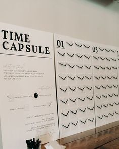 the wall is covered in black and white paper that says, time capsule on it