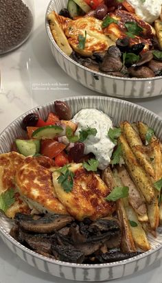 two bowls filled with food on top of a white countertop next to each other